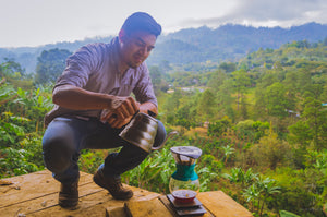 Abel Dominguez of Bloom's making a pour over while overlooking his farm.